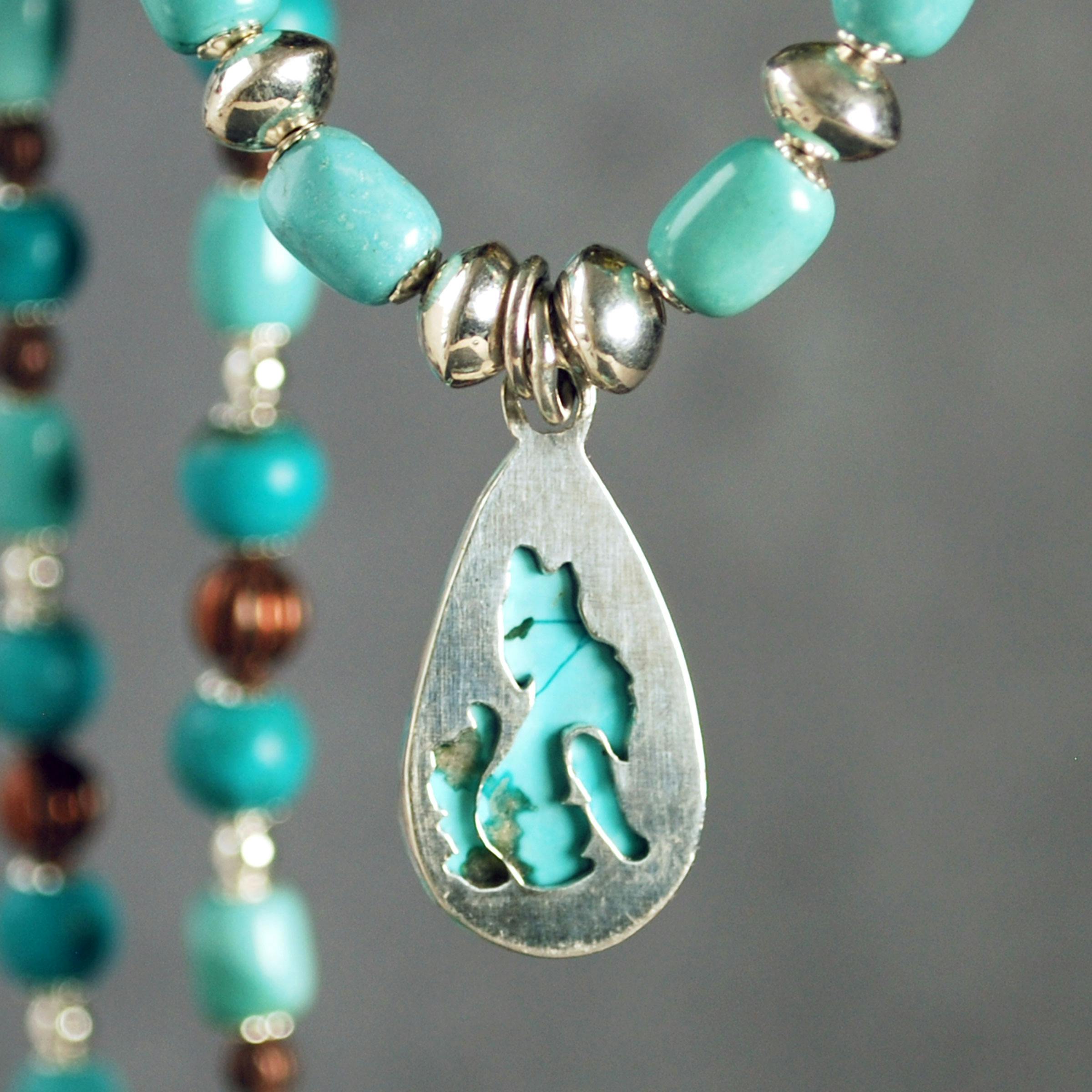 Back of turquoise pendant, wolf cut-out