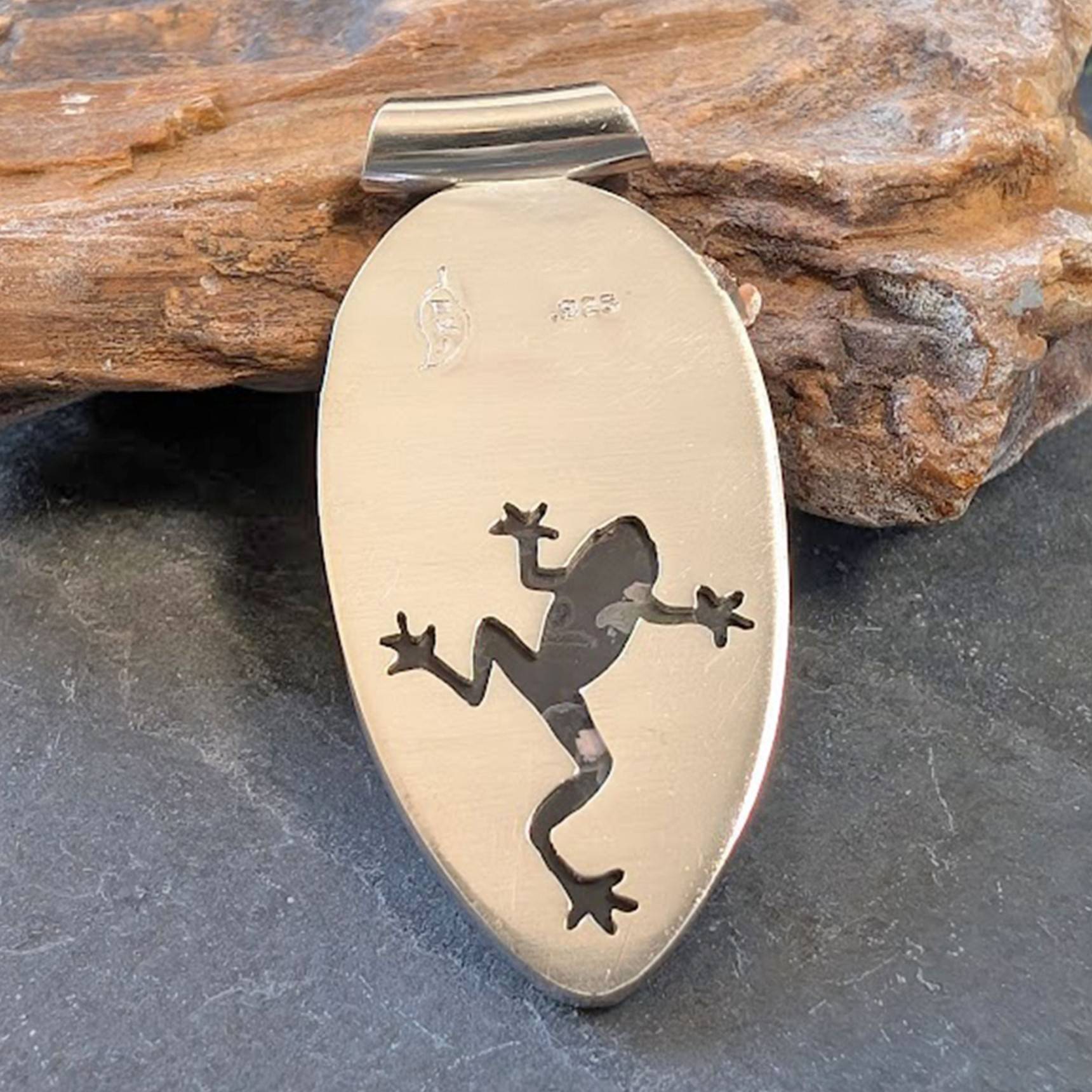 back of frog pendant with frog cut-out behind the stone