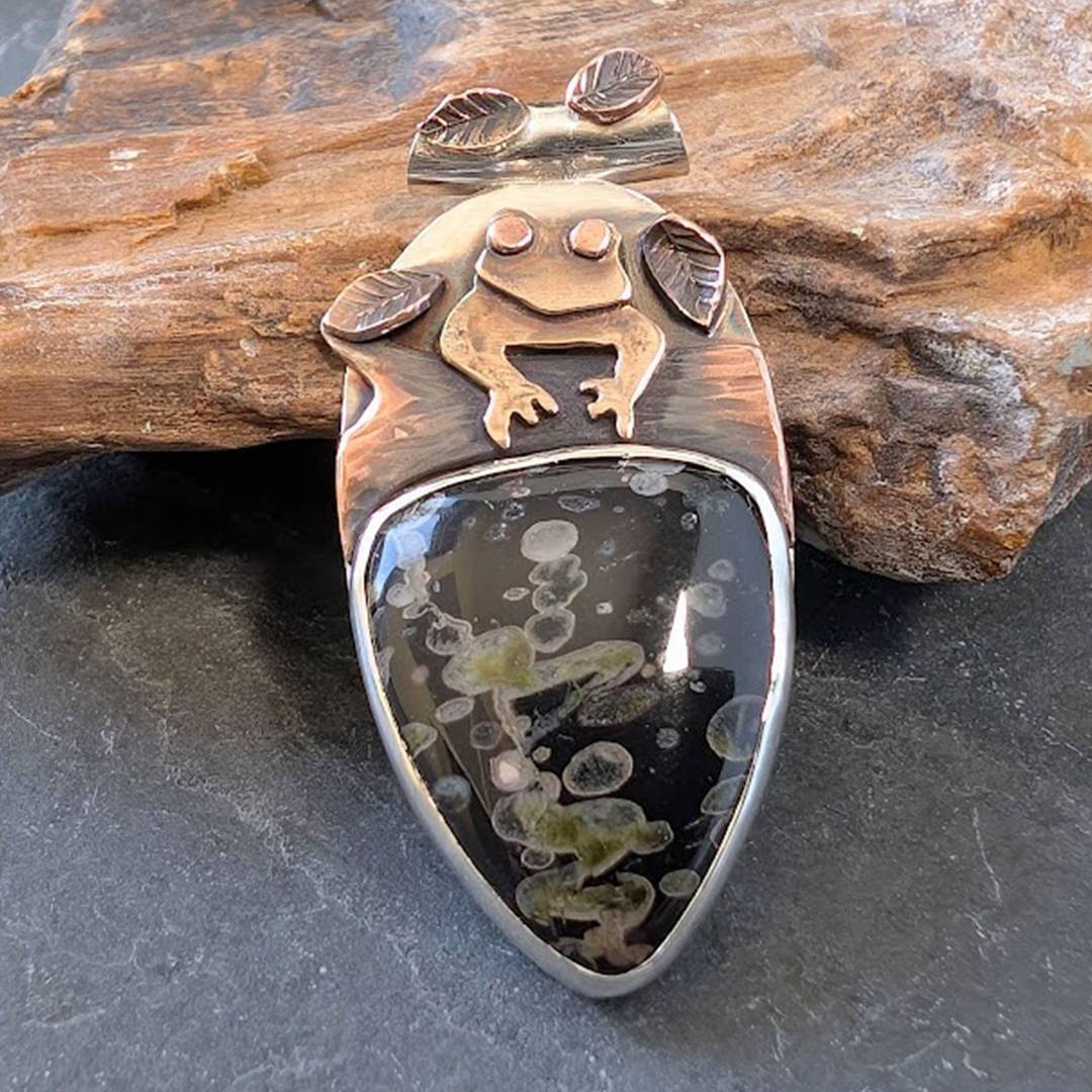silver pendant with frog, copper log, leaves and lilypad jasper