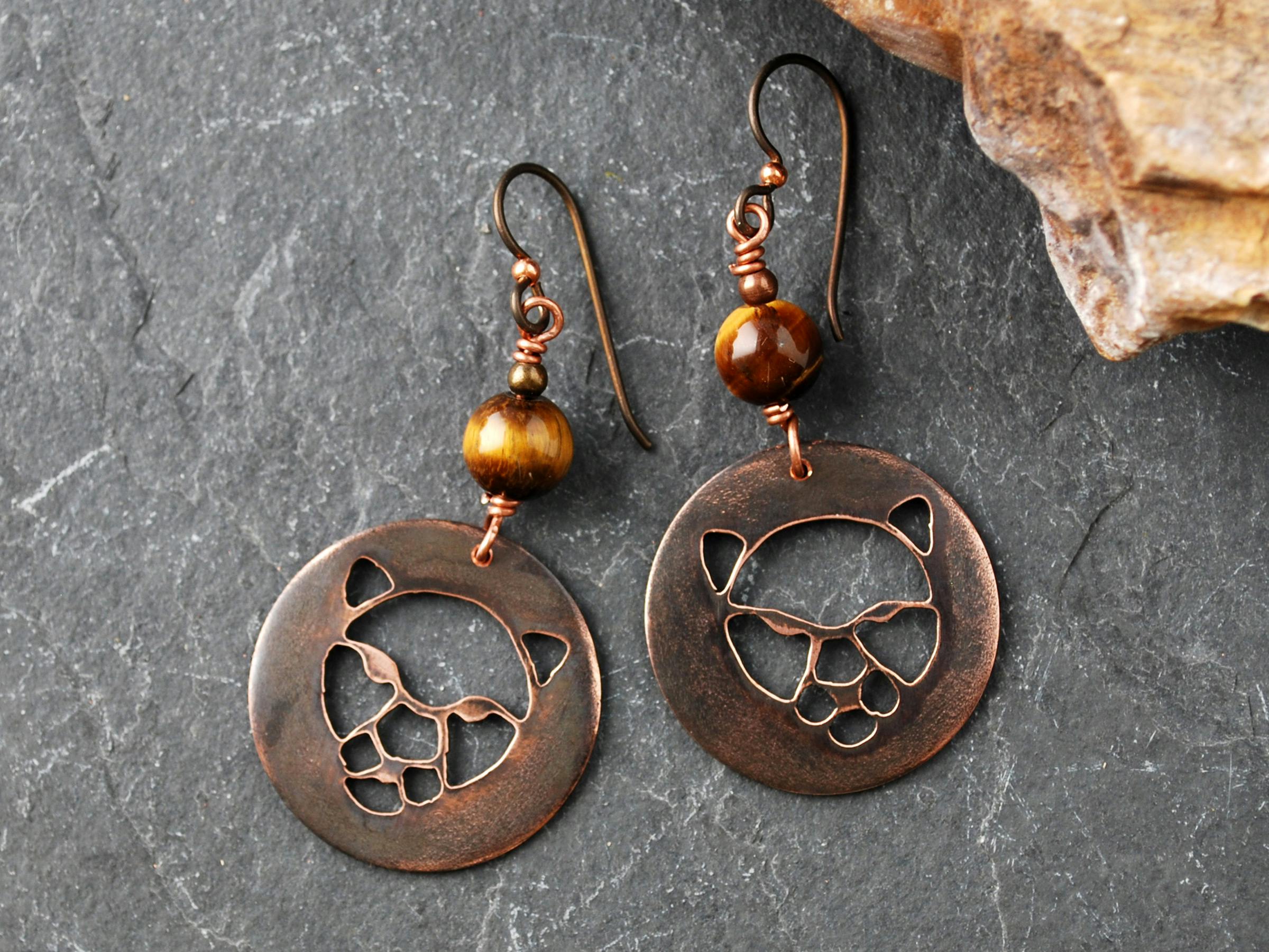 Copper earrings with wildcat faces cutout