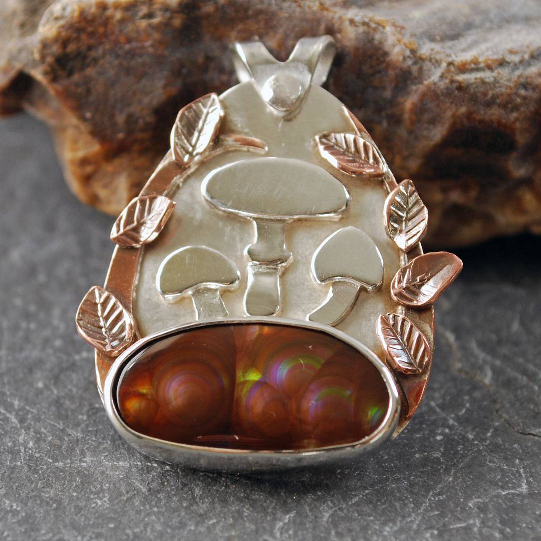 Pendant with Fire Agate and three silver mushrooms above stone