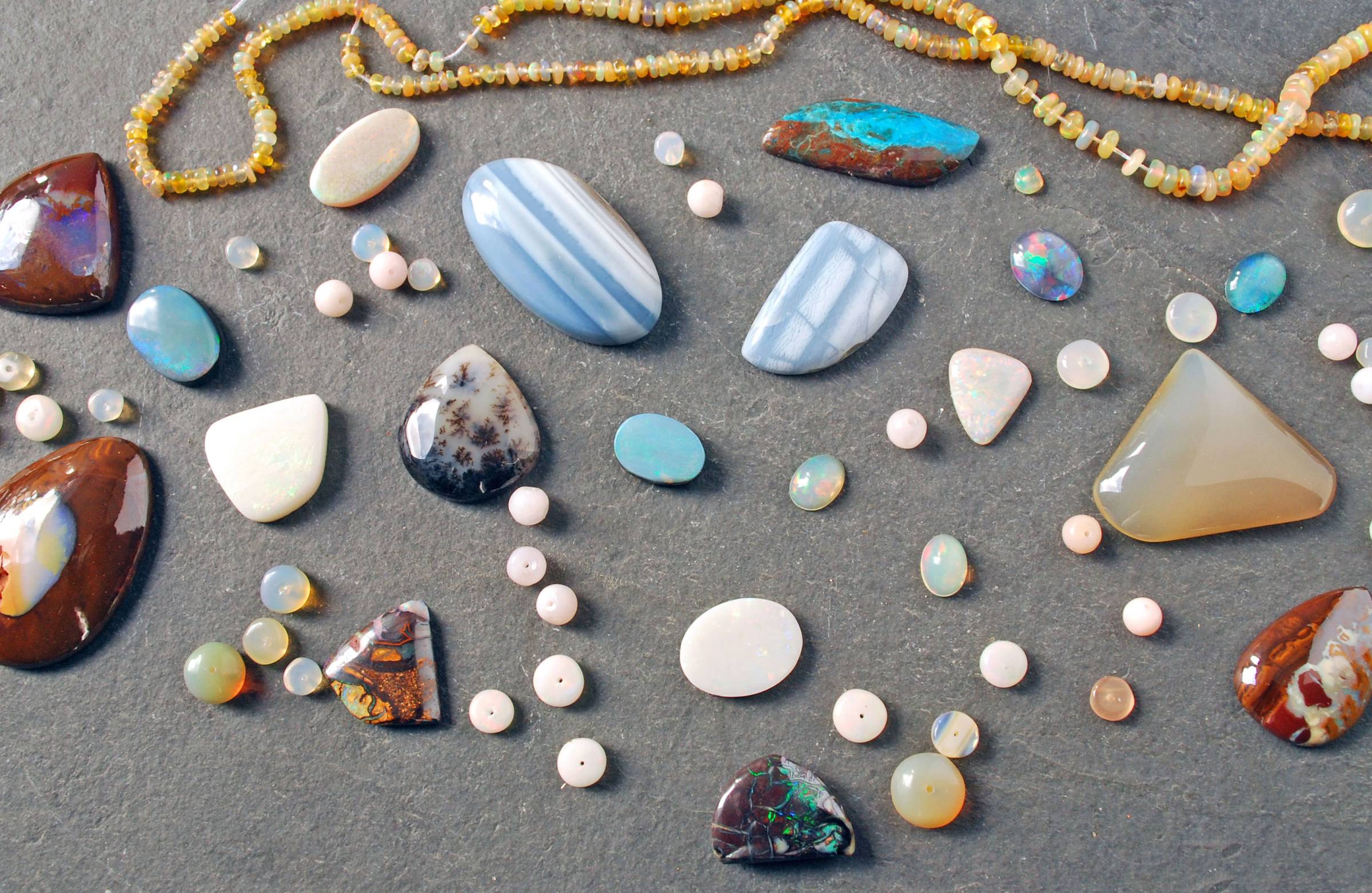 group of various opals: gem opals, common opals, boulder opals, beads and cabochons