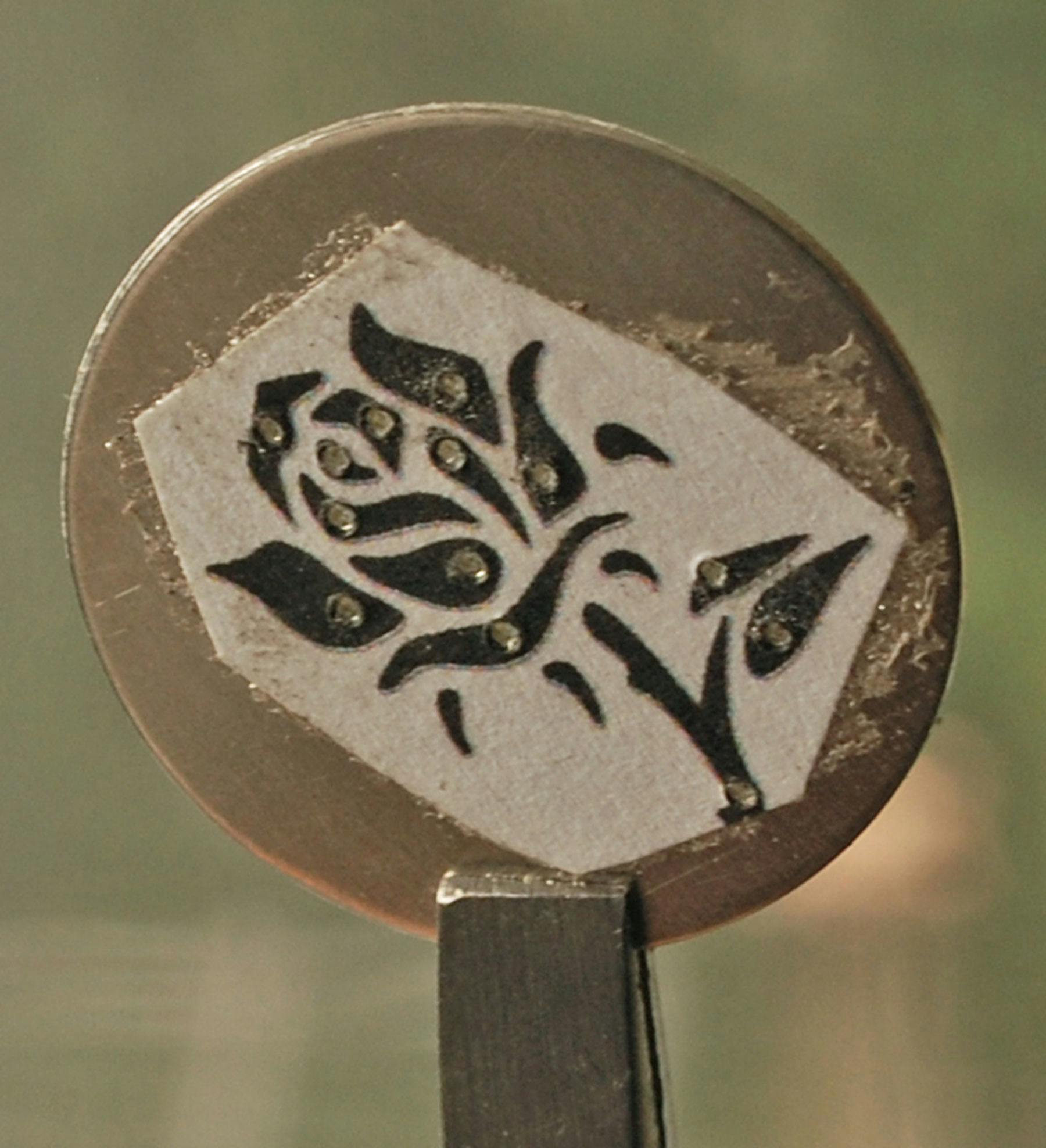 Design on metal with pierced holes in each design section