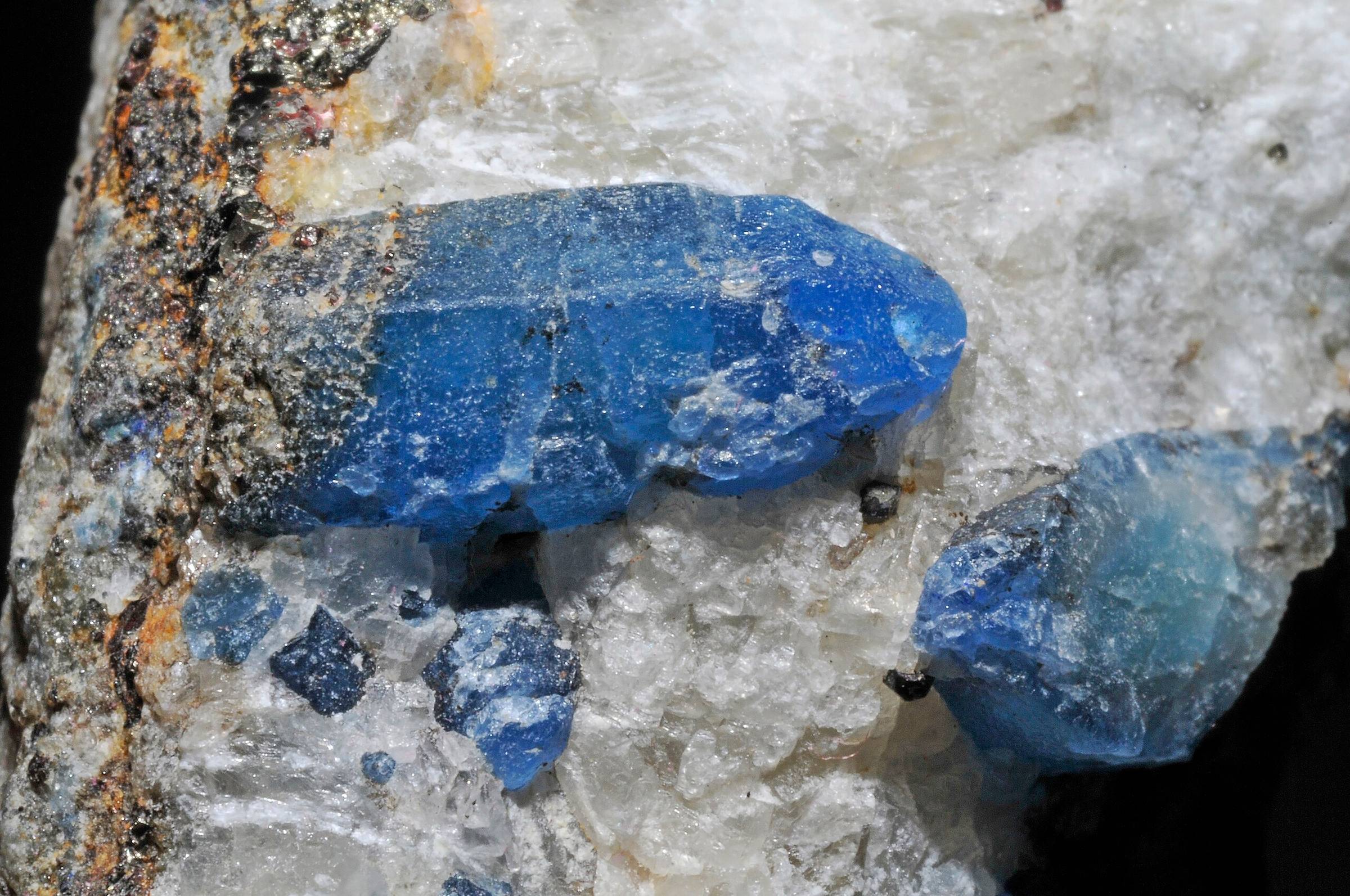 Pieces of afghanite crystals in white stone.