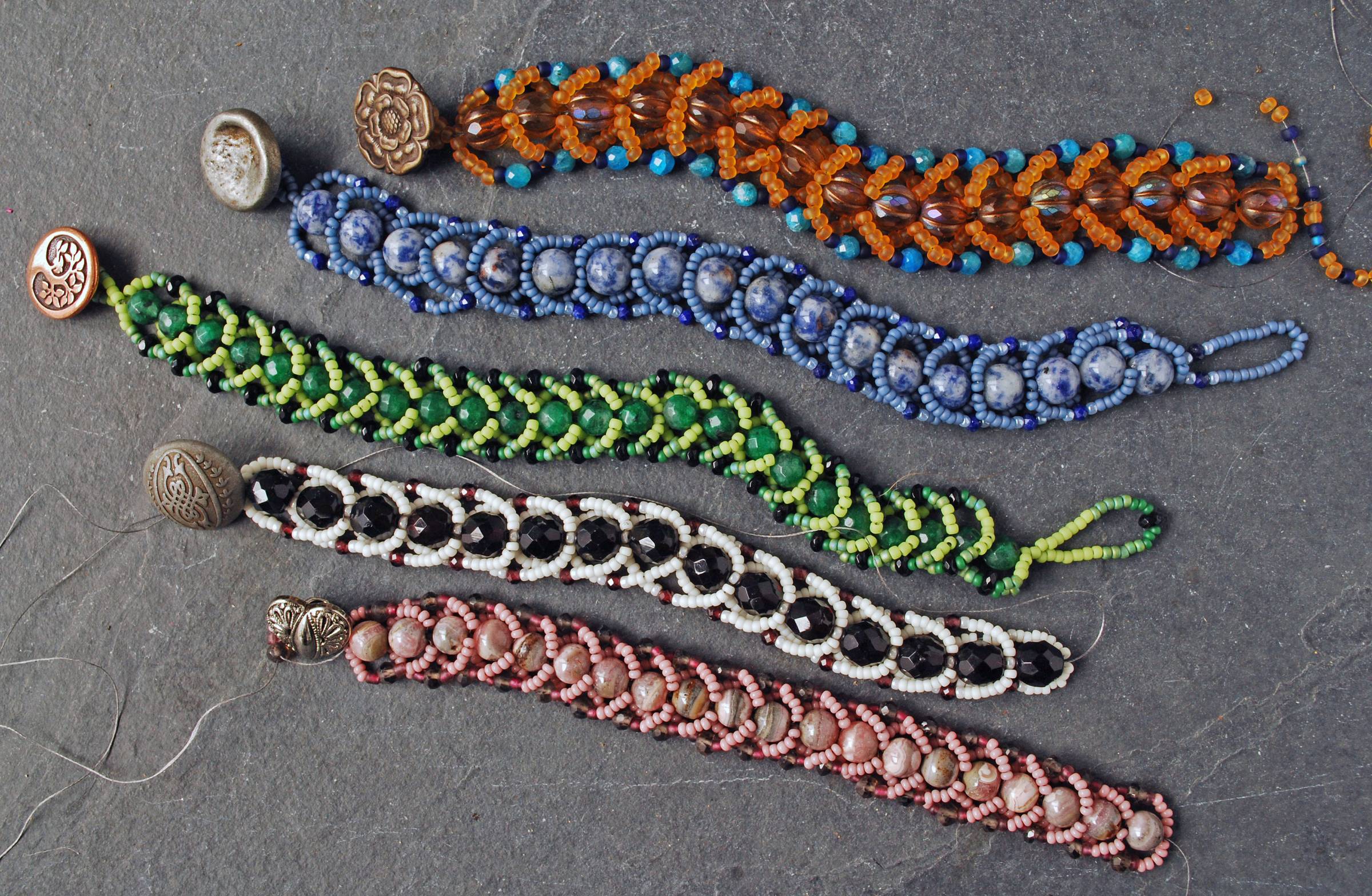 Five beaded bracelets, described in the paragraph below the picture
