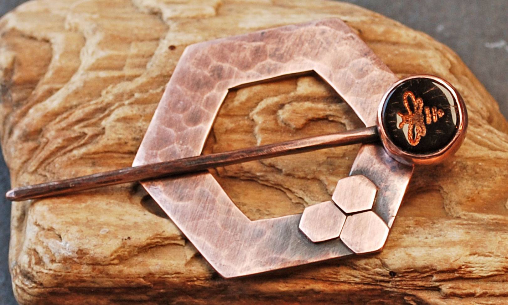 copper scarf pin with glass disc bead with impressed bee set onto the pin