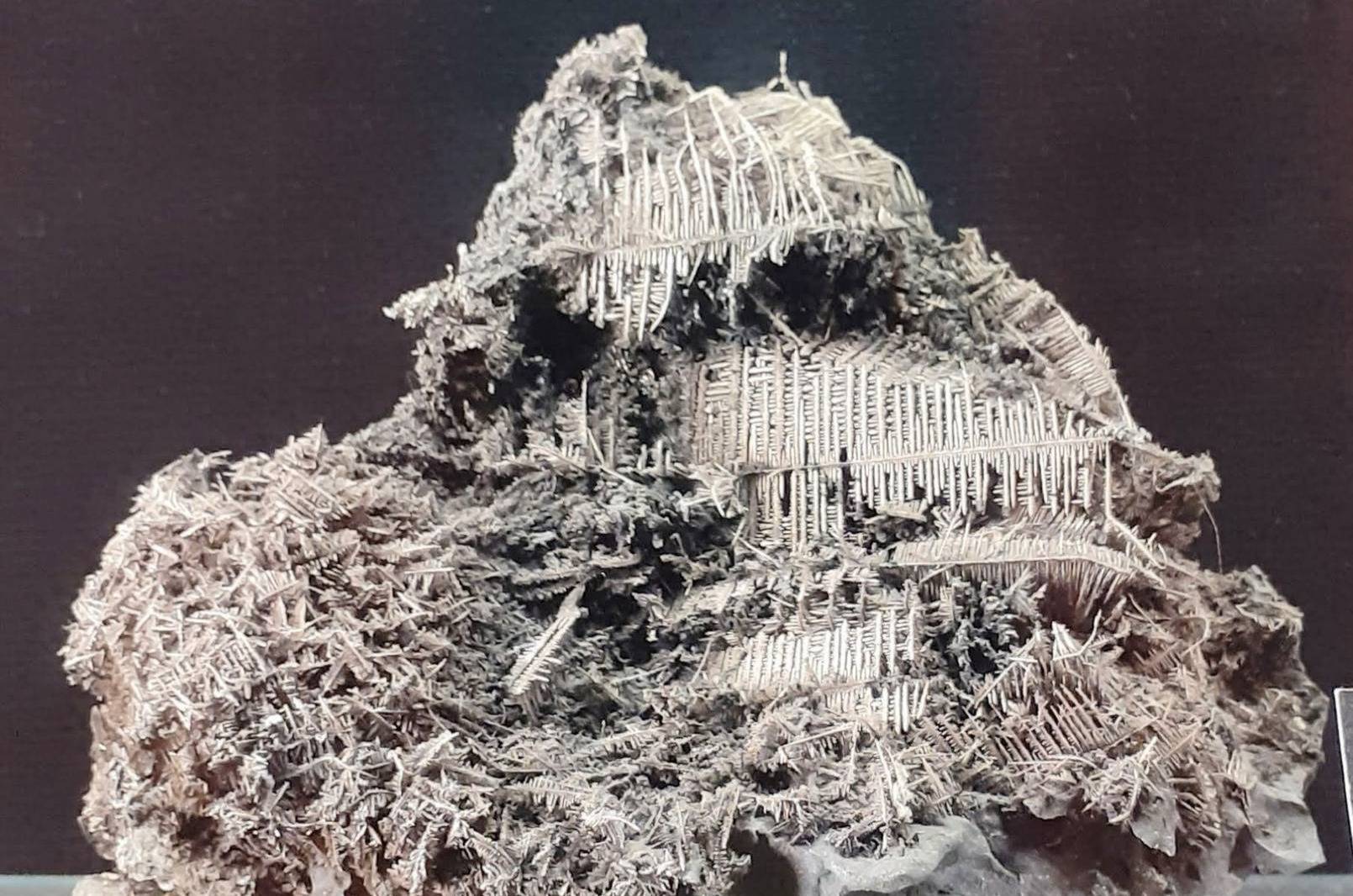 Image of a chunk of native silver showing thin geometric shapes