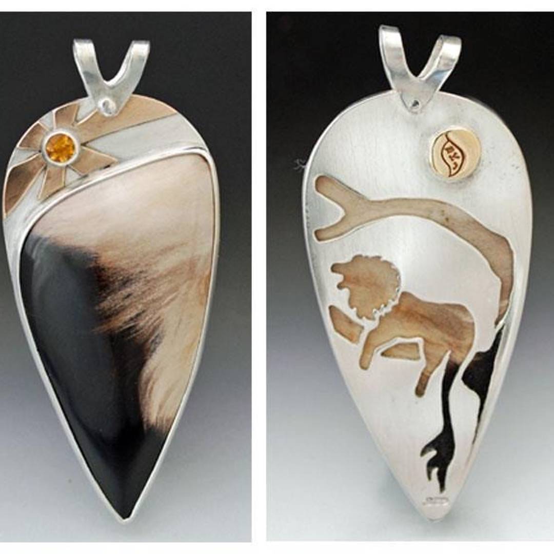 Pendant with petrified wood cabochon, sun and citrine on the top, lion cut out of the back