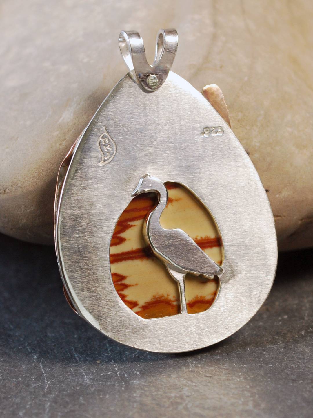 Back of pendant with heron and cut out window to the stone