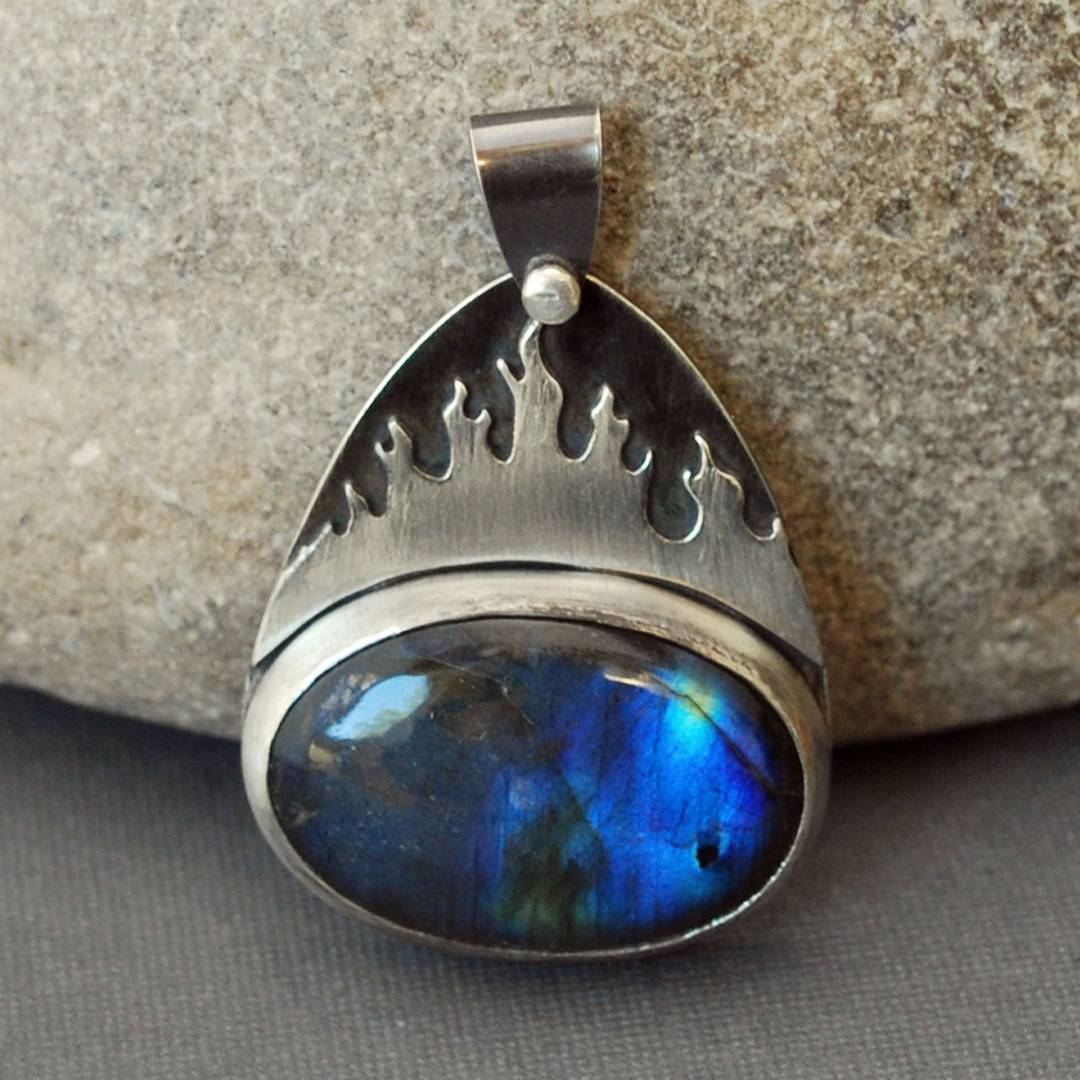 Silver pendant with deep blue labradorite and silver flames.
