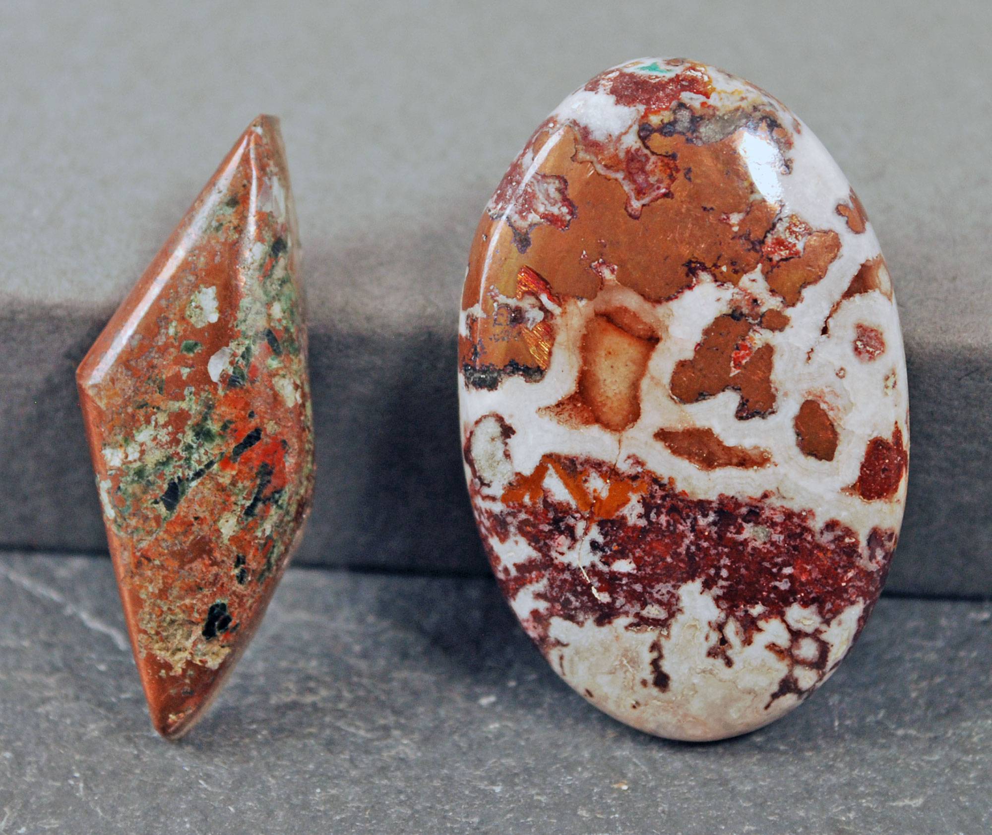 Two cabochons with native copper in them