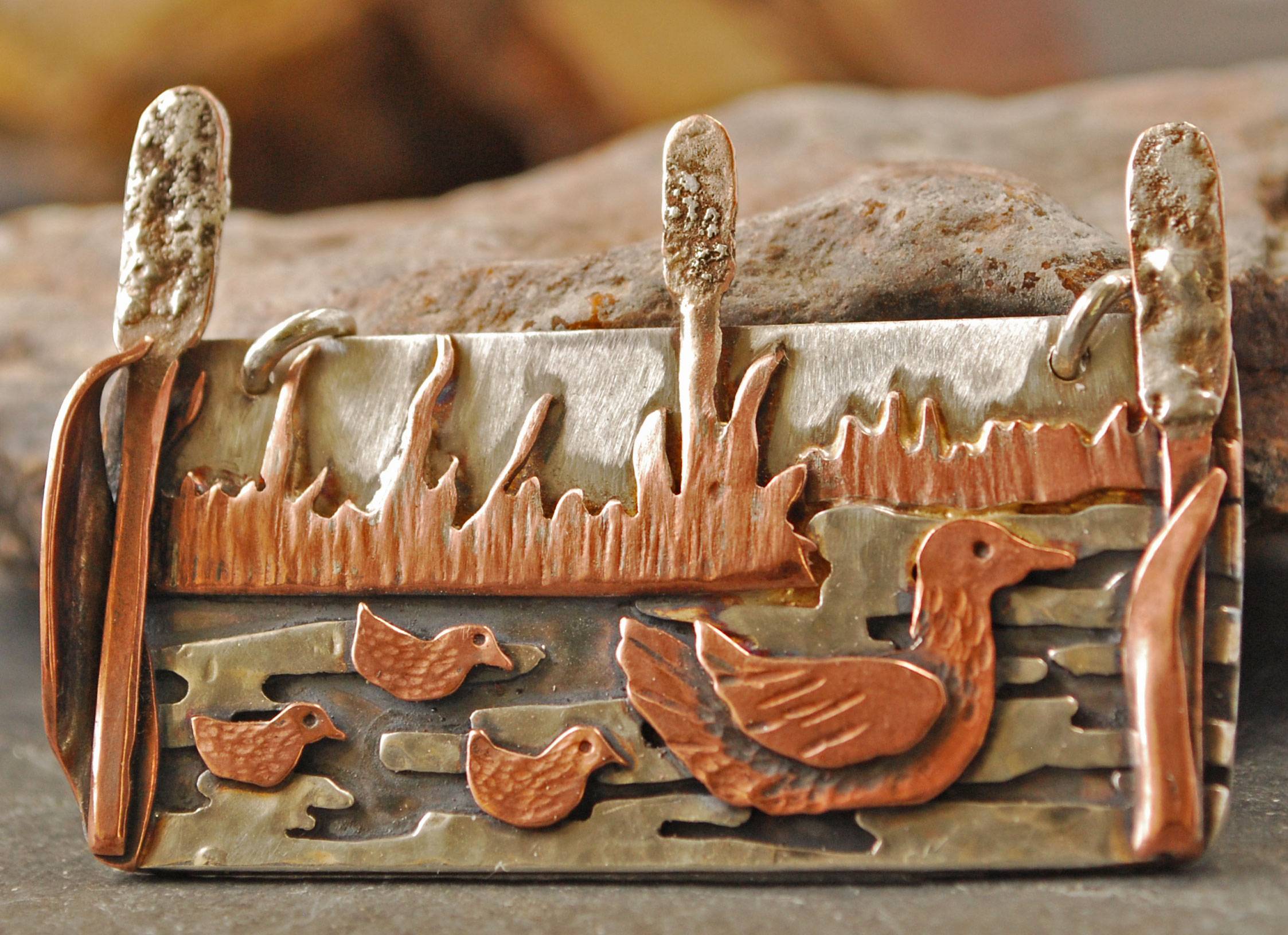 Silver pendant with copper ducks, cattails