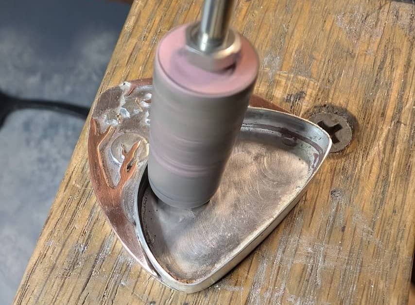 Cylinder silicon wheel being used to clean and polish area behind where the cabochon will be set