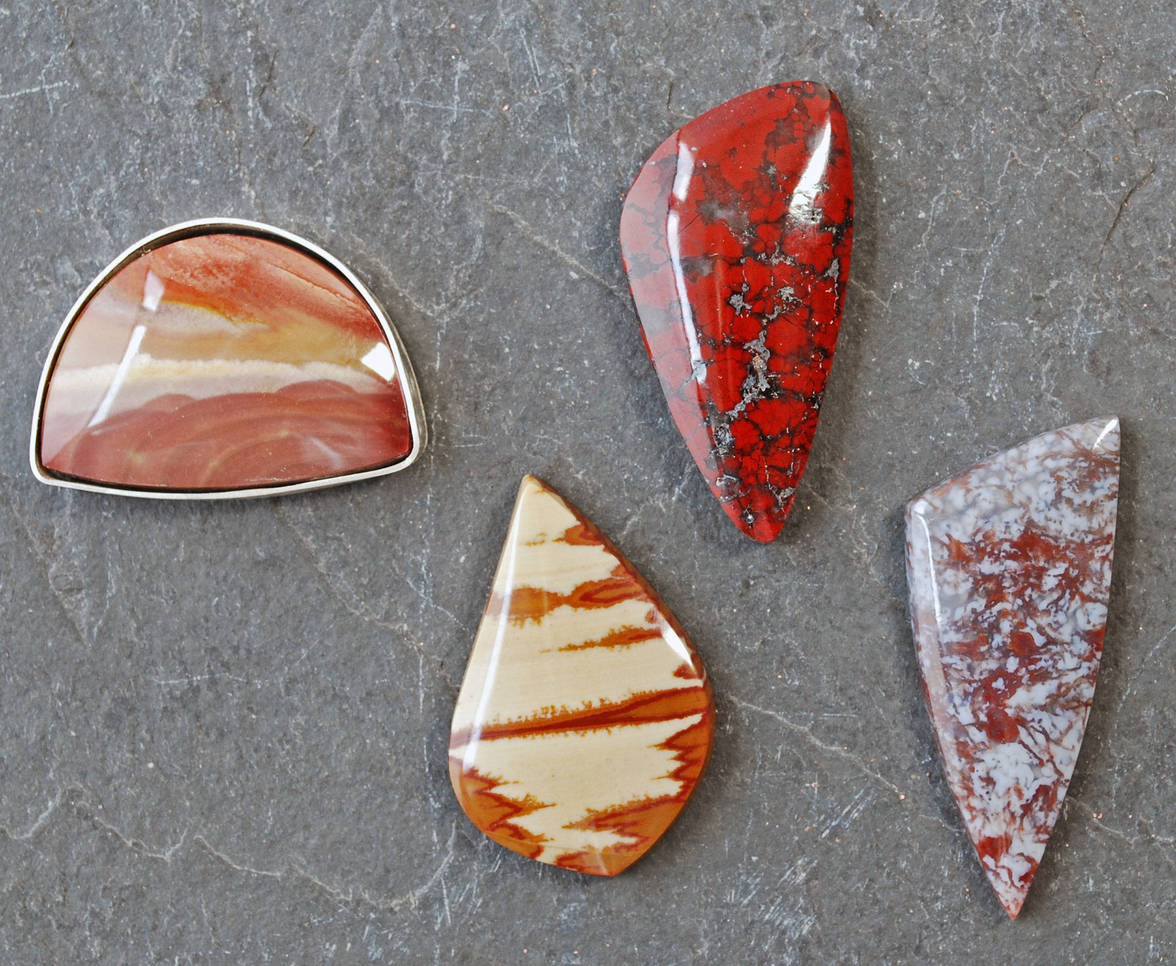 Four cabochons: picture jaspers, red jasper with hematite, purple moss agate