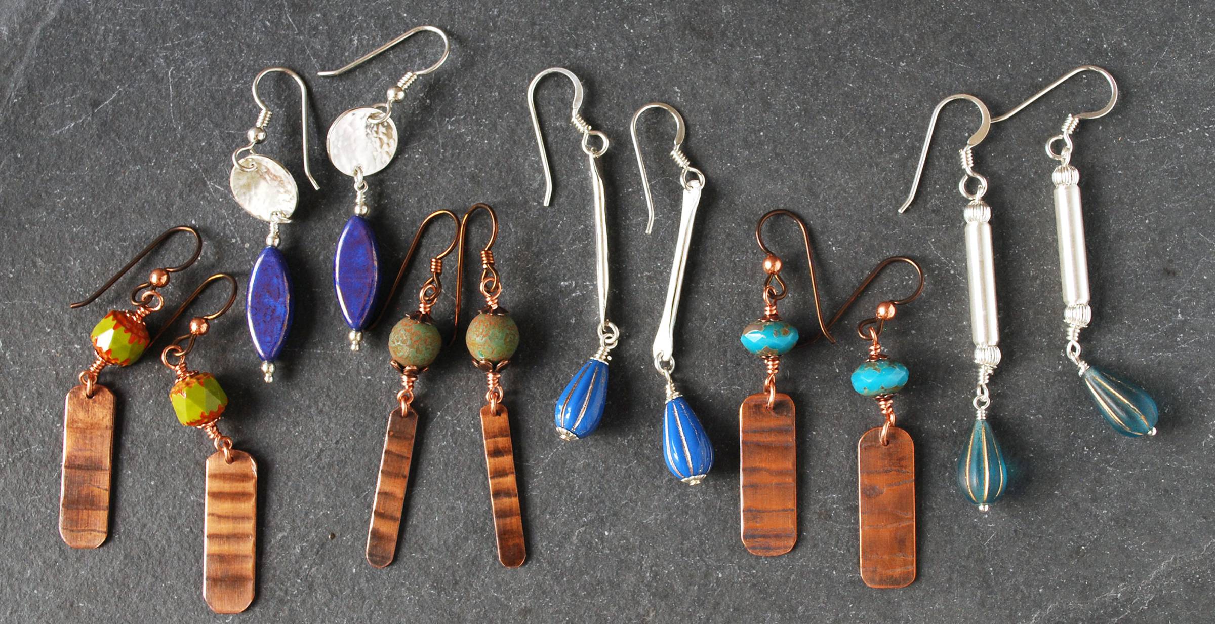 group of earrings featuring copper and silver dangles with Czech glass beads