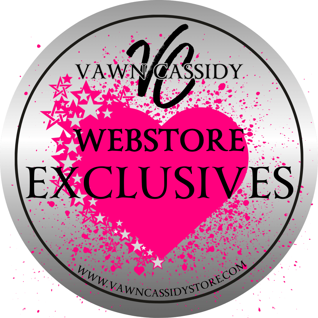 A circular emblem featuring the text "Vawn Cassidy Webstore Exclusives" in bold black letters. The background includes a large pink heart with pink splatters and star designs, set against a silver backdrop. The website "www.vawncassidystore.com" is written at the bottom edge of the emblem.
