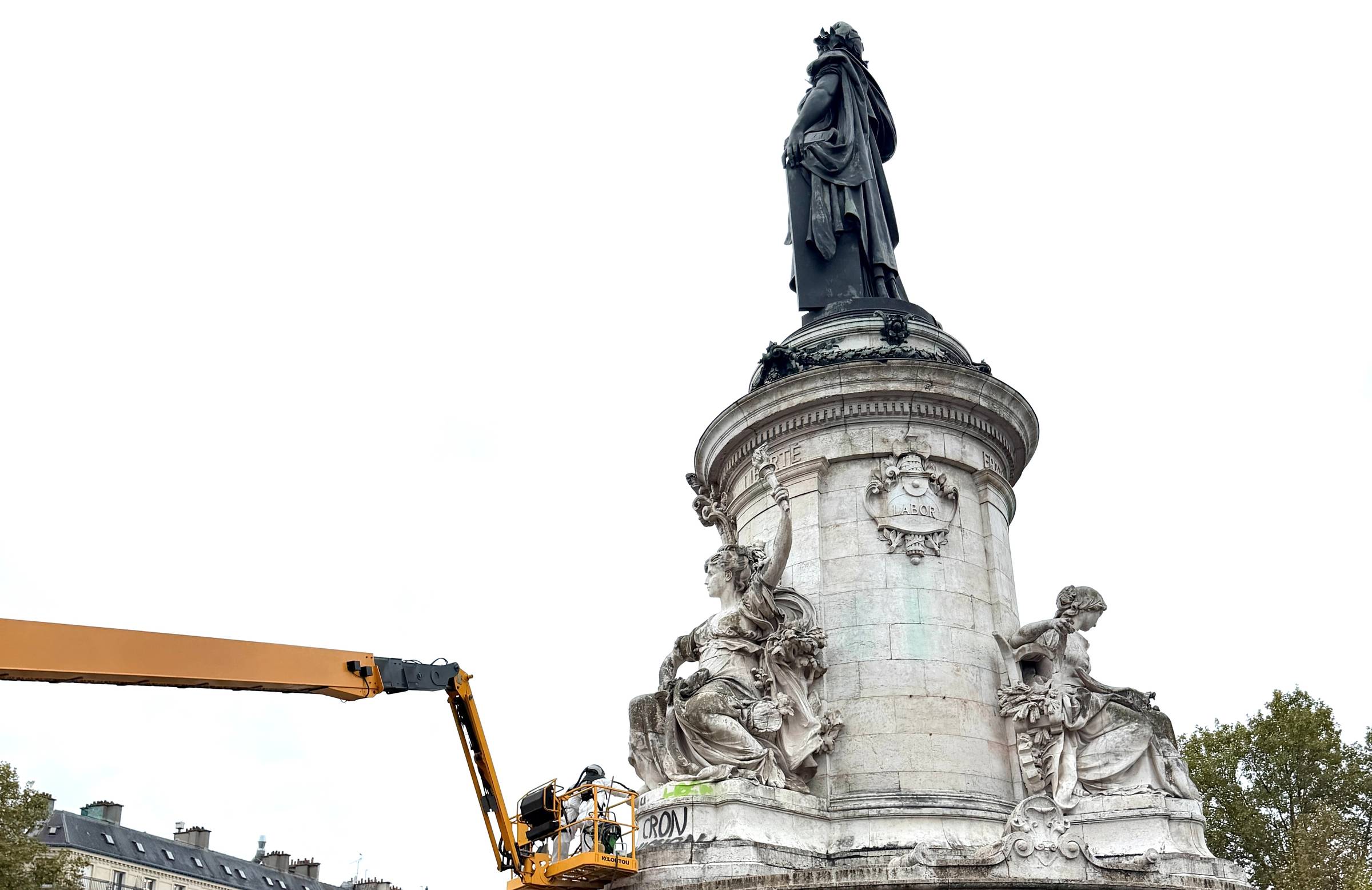 Cleaning slogans from Republique statue