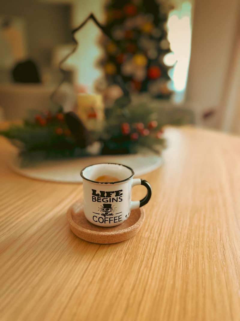 A small cup of coffee on a wooden table.