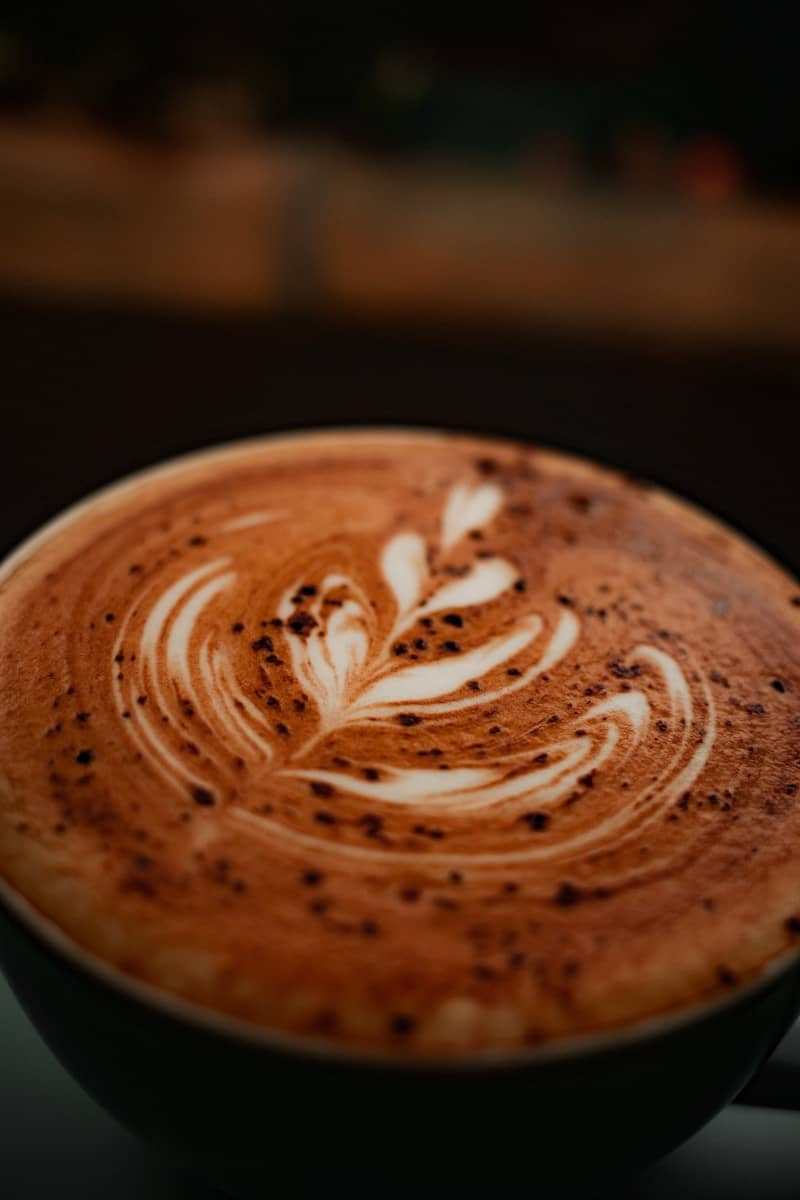 A close-up of latte art on a cappuccino