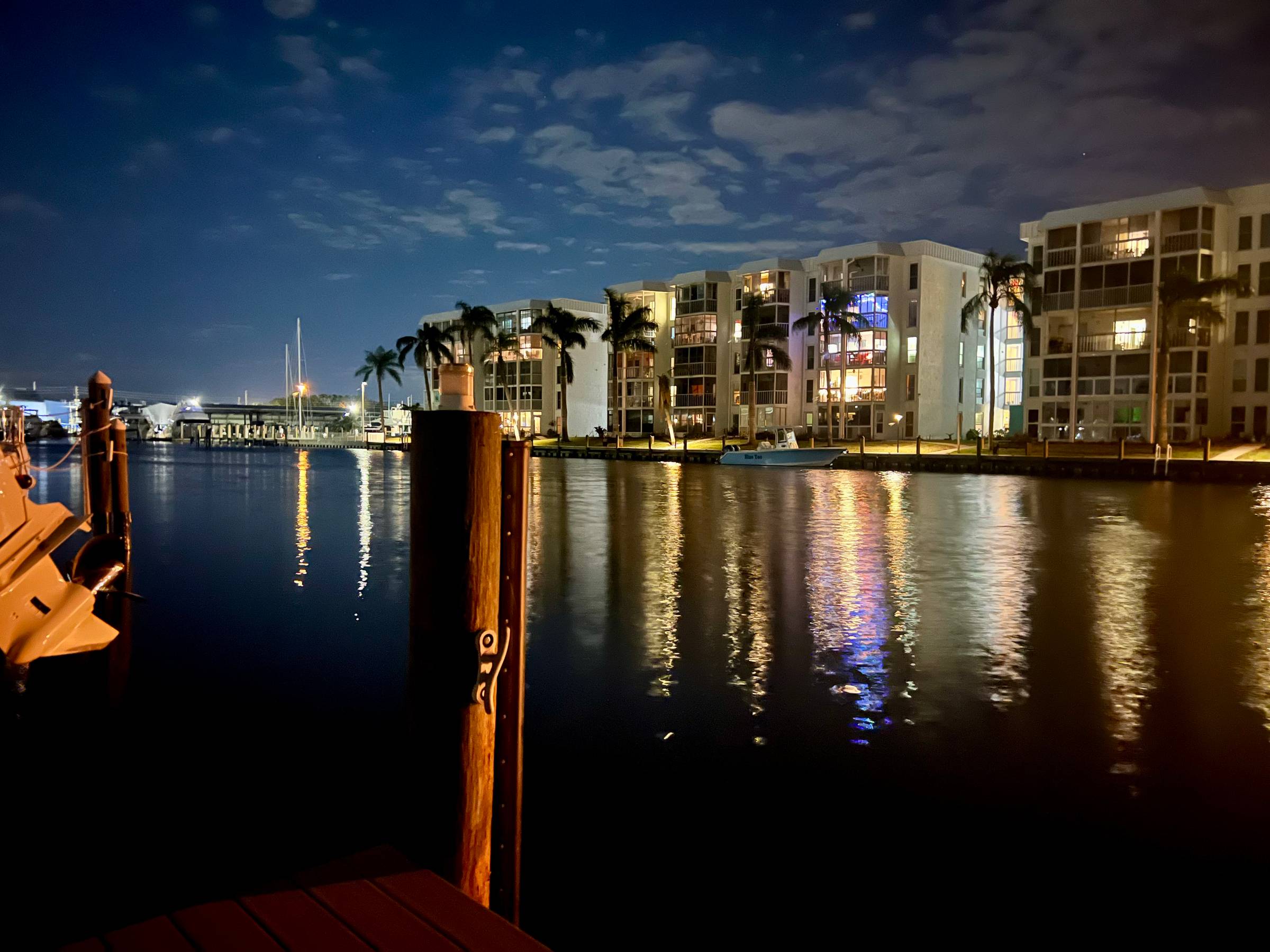 A night view of condos and a canal 
