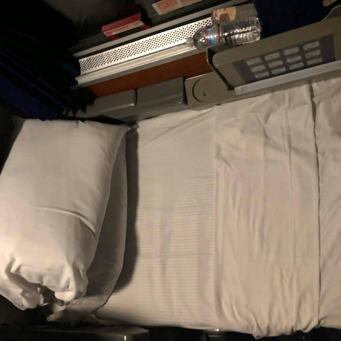 The lower bunk of the roommette ready for a nights rest. A pillow on awaits my head and a water bottle to keep me hydrated. 