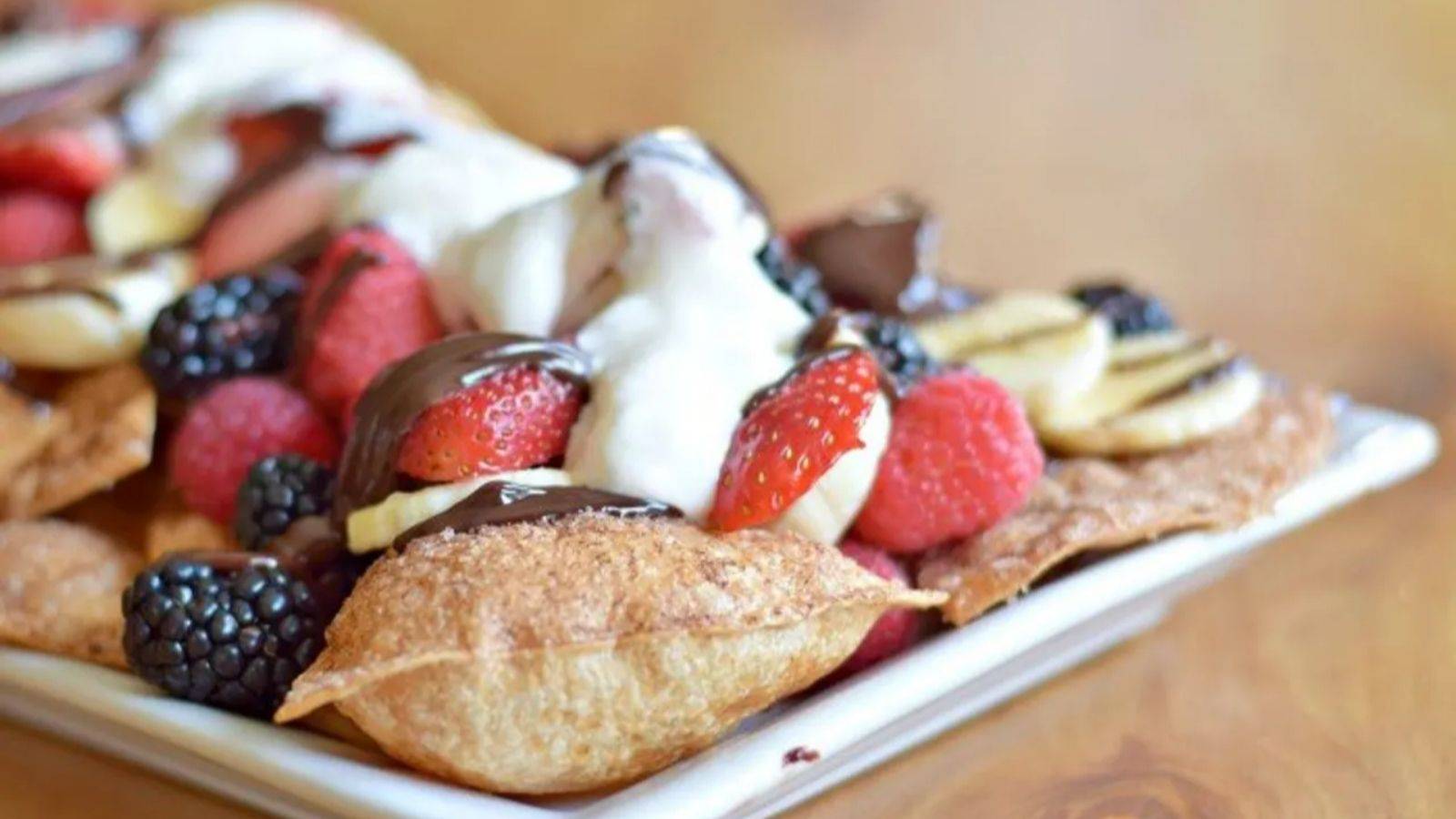 Dessert nachos on a white plate.