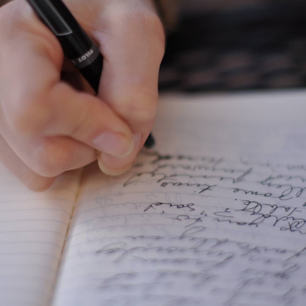 Someone writing by hand.