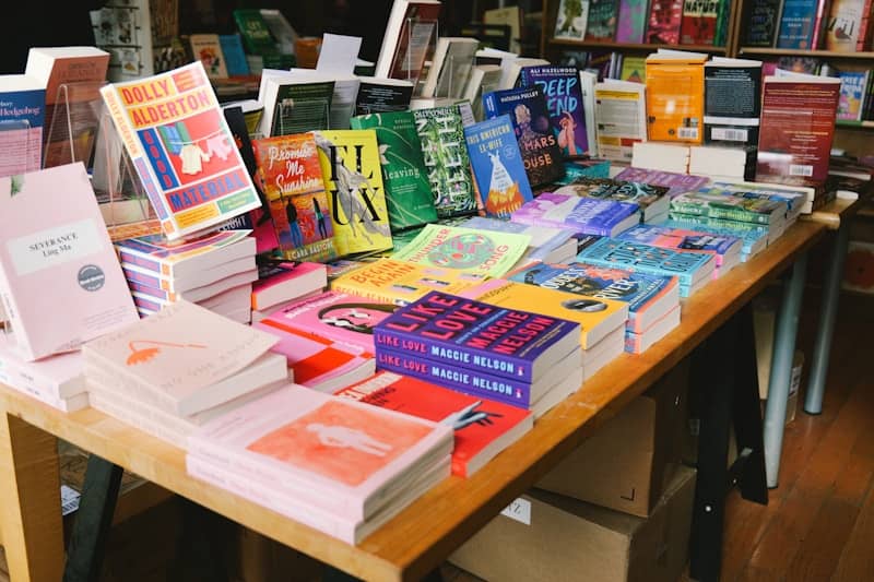 Books neatly arranged on a table in a bookstore.