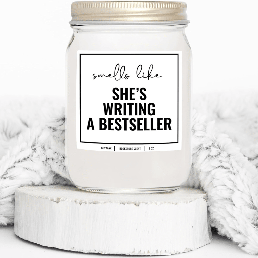 White candle that says she's writing a bestseller