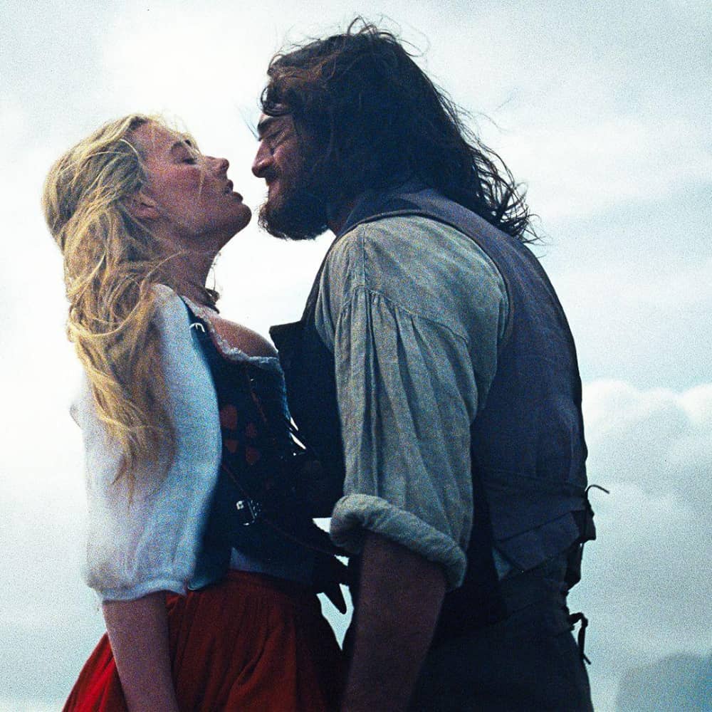 Actors in a near embrace in a period romance drama. 
