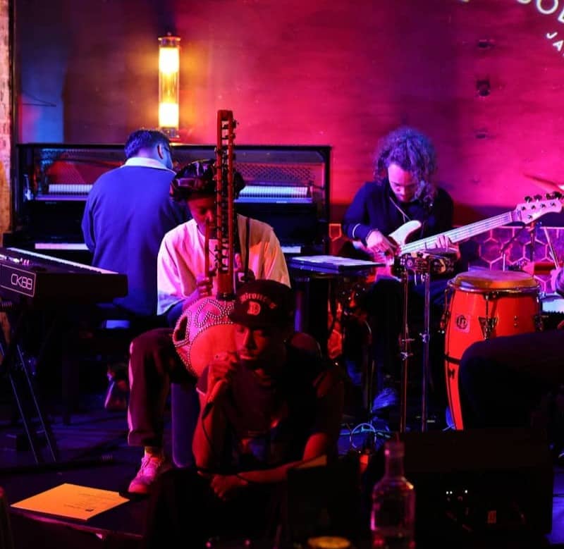 Musicians performing live jazz in a dimly lit club.