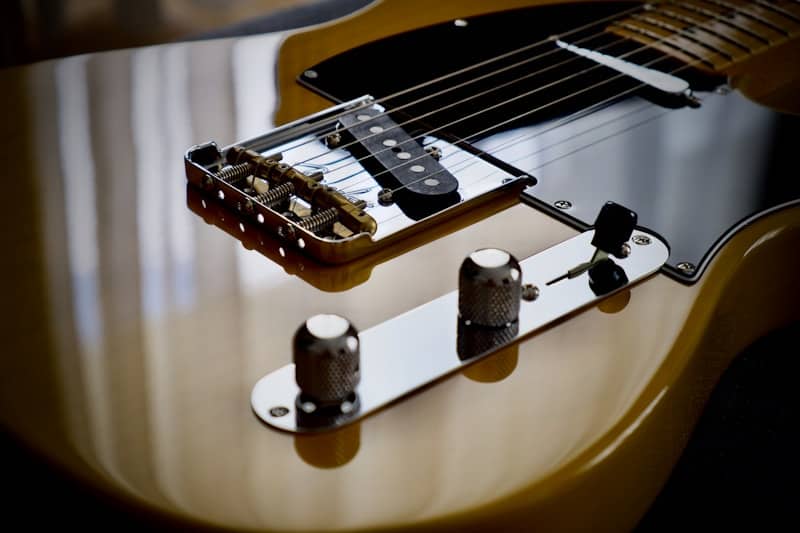 Electric guitar body with bridge, pickups, and control knobs.