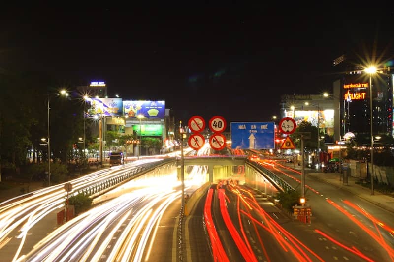 City street at night with light trails from cars