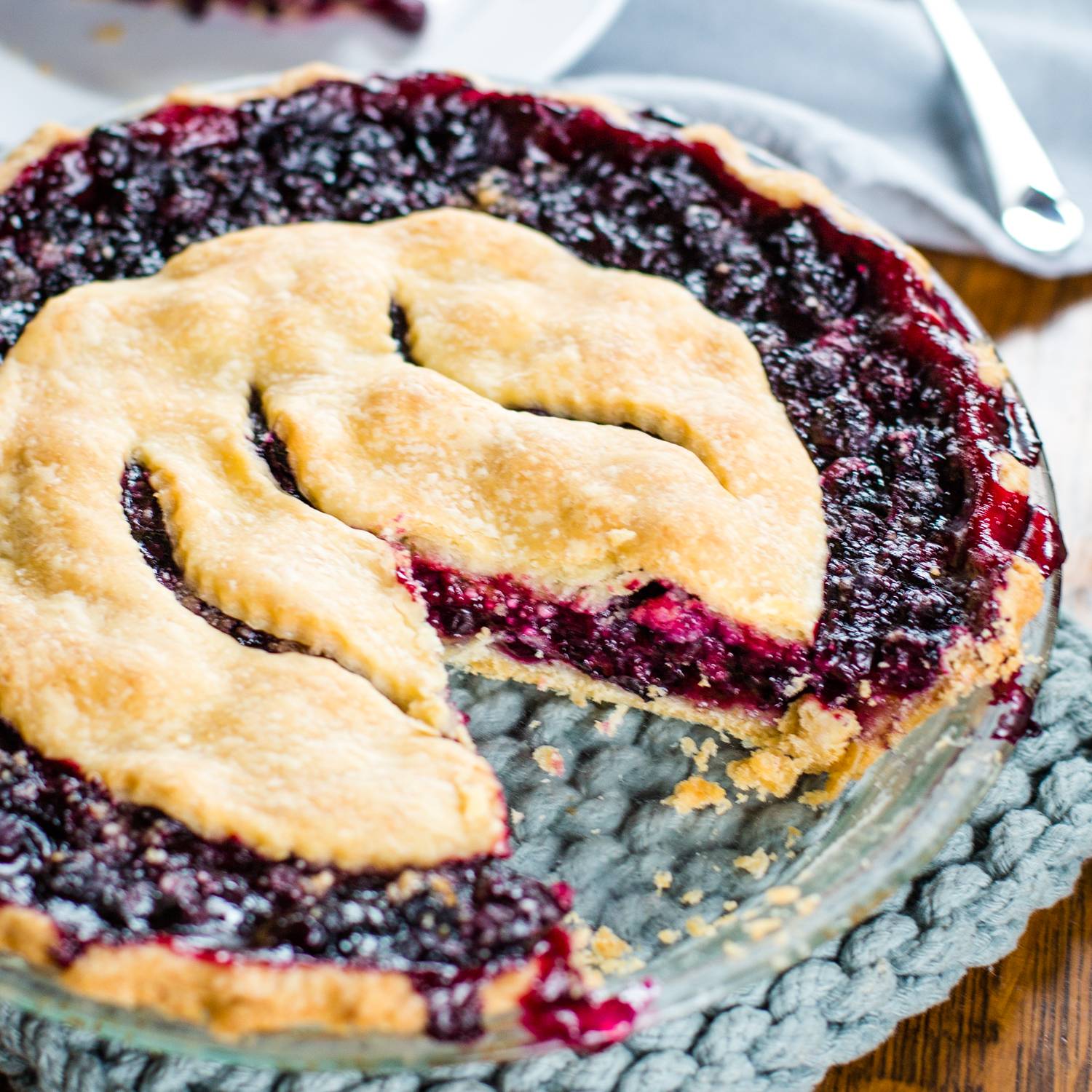 blue berry pie with slice removed