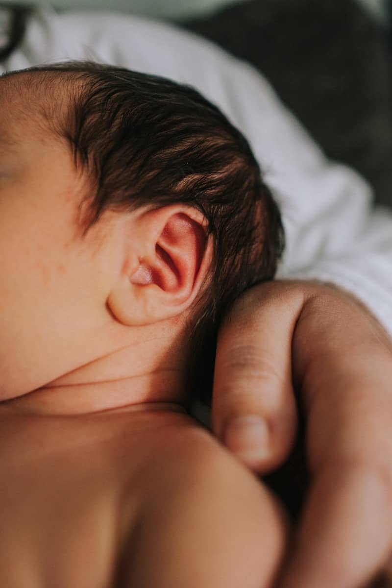 A close up of a person holding a baby