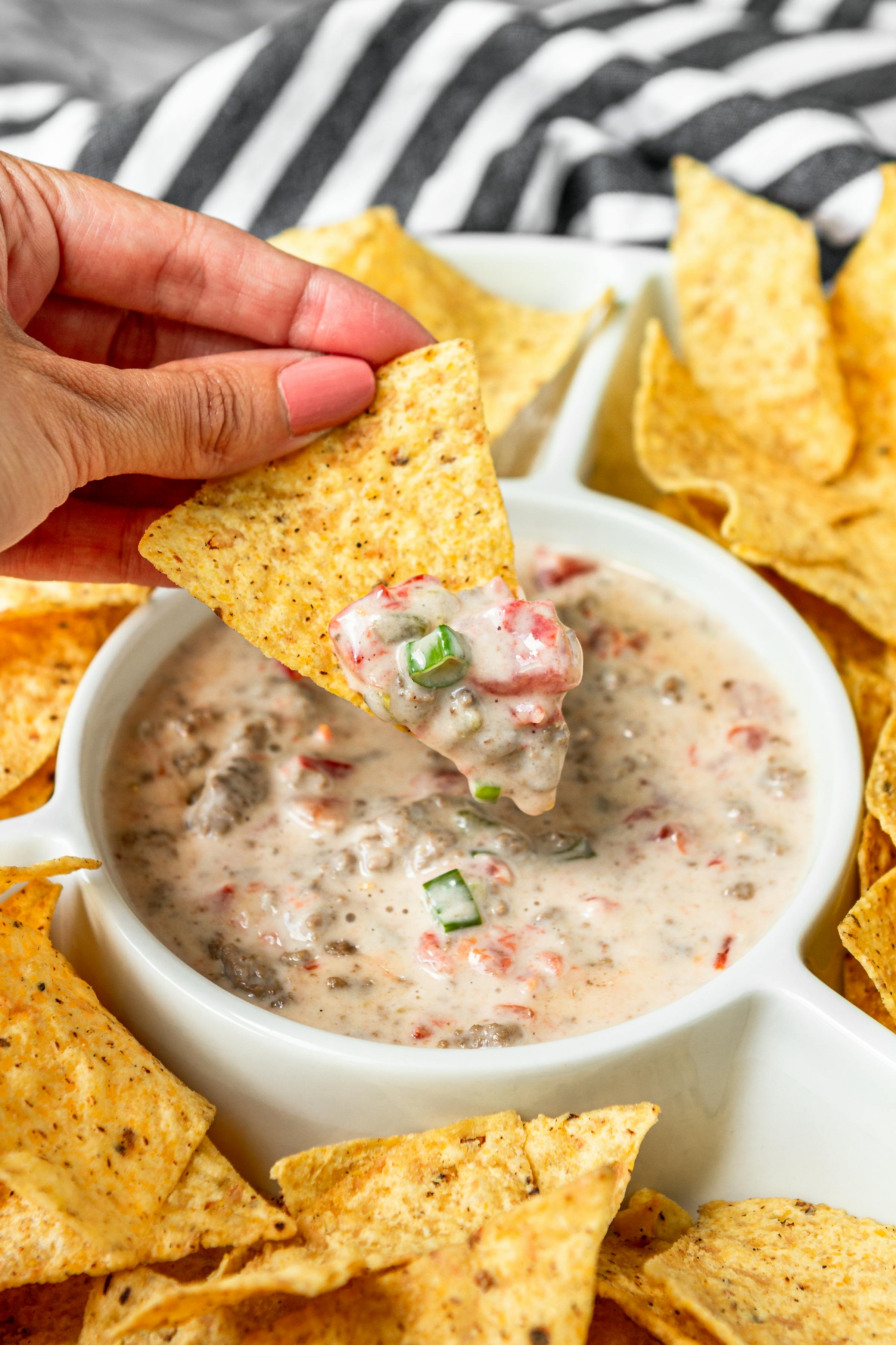 beefy white queso dip on a tortilla chip