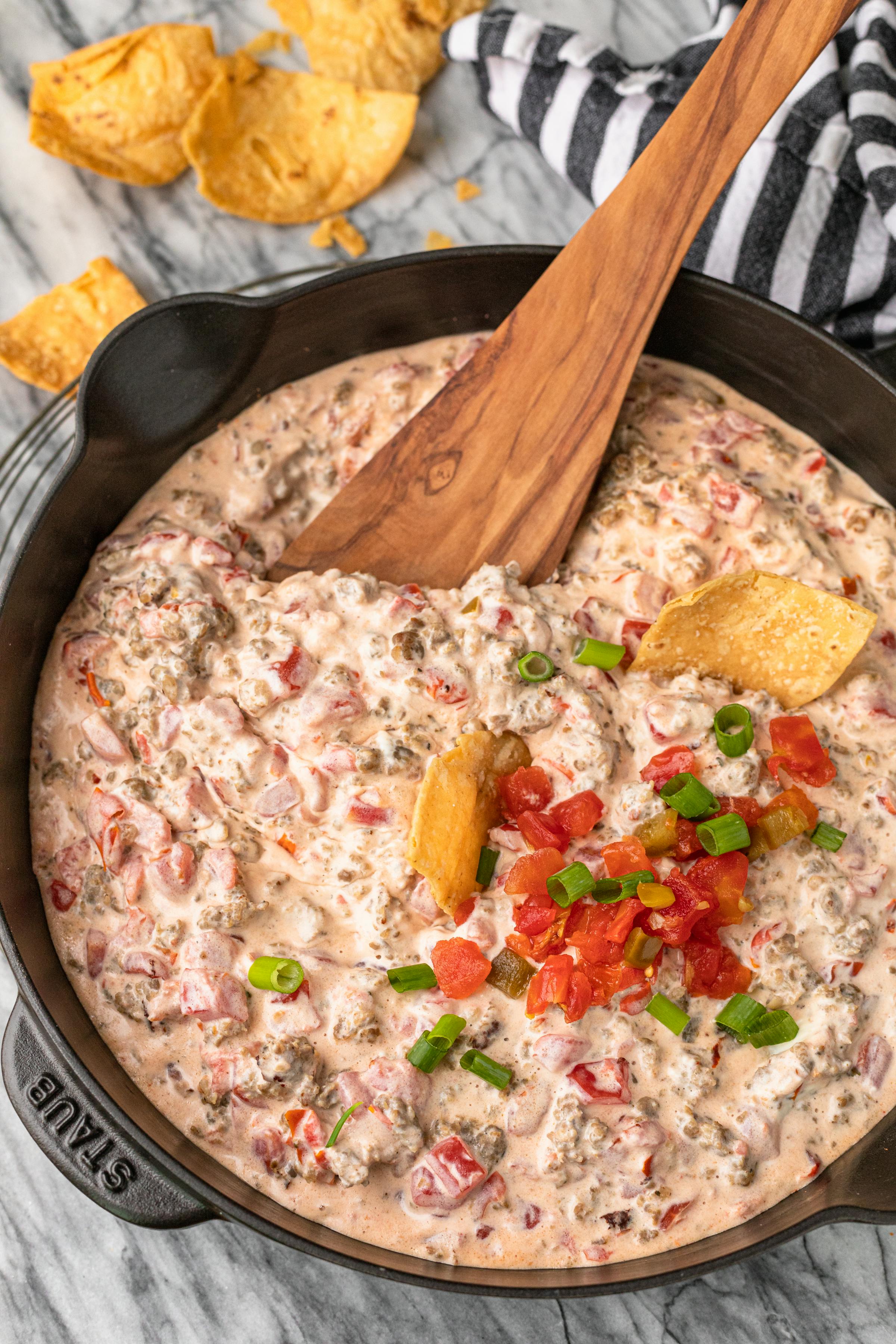 sausage cream cheese dip in a cast iron skillet