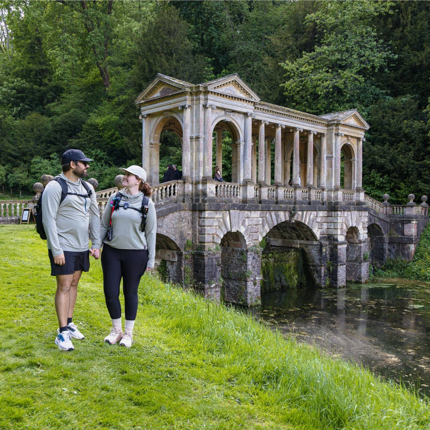 Two people standing in front of an ornate bridge in Bath, England