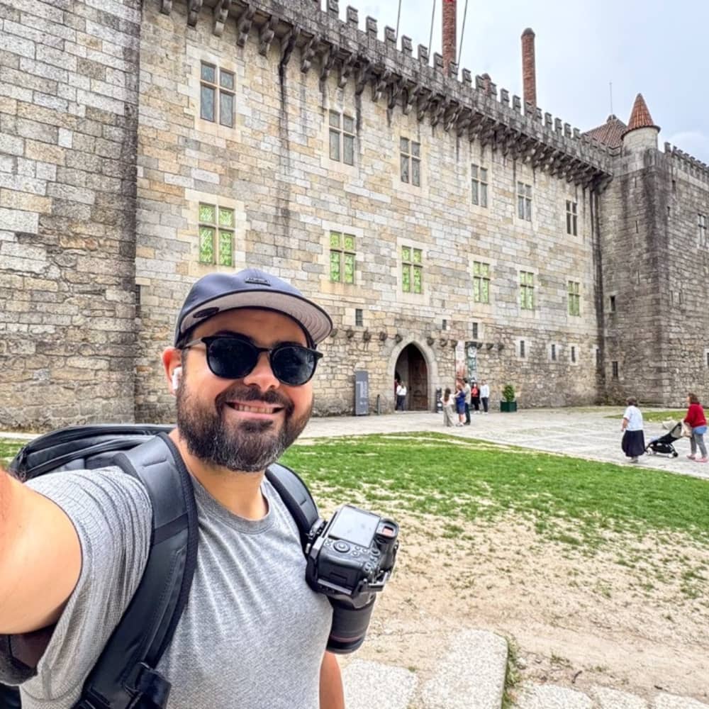Joey standing in front of a palace in Guimarães, Portugal