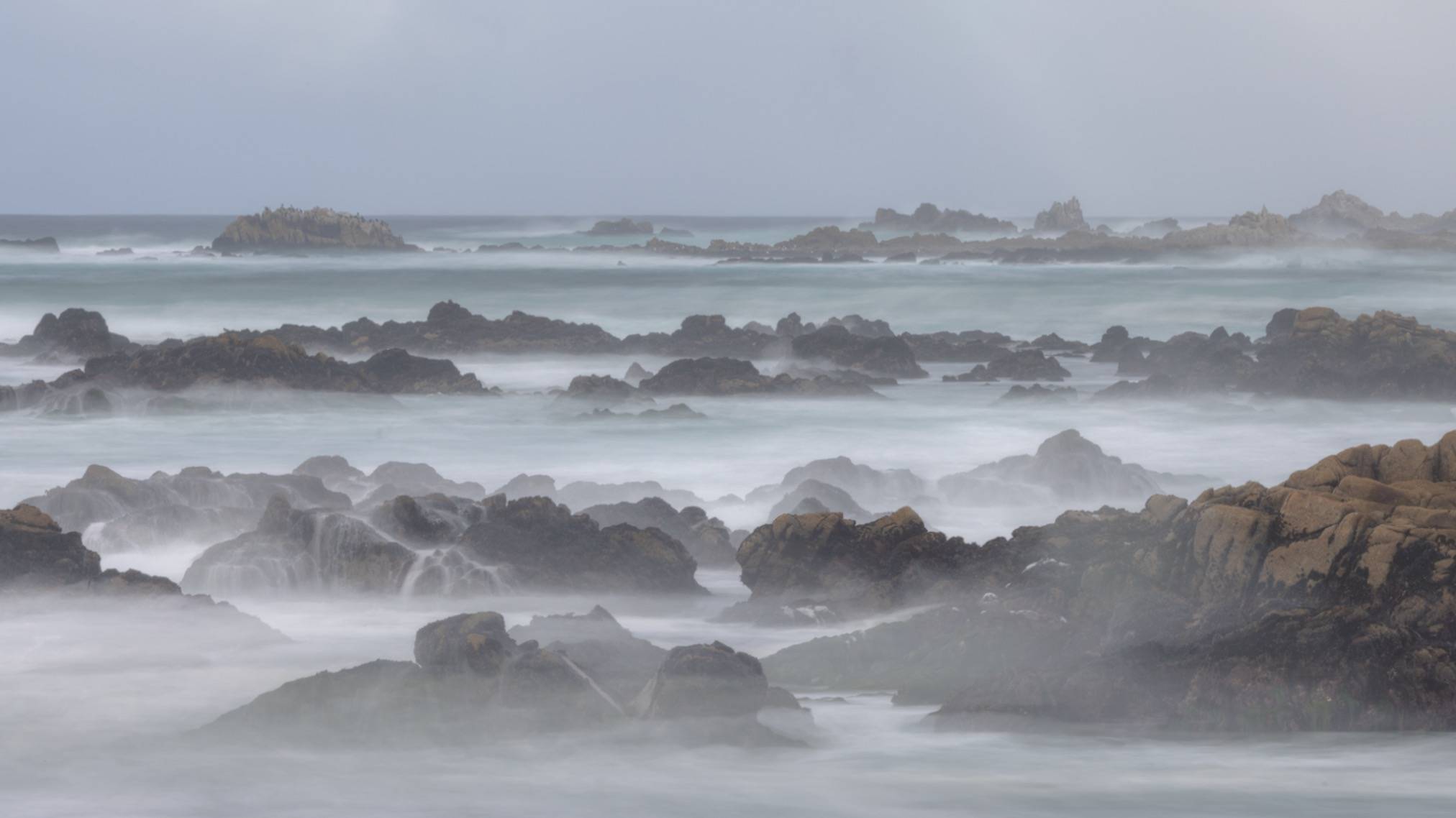 waves crashing on rocks with slow exposure