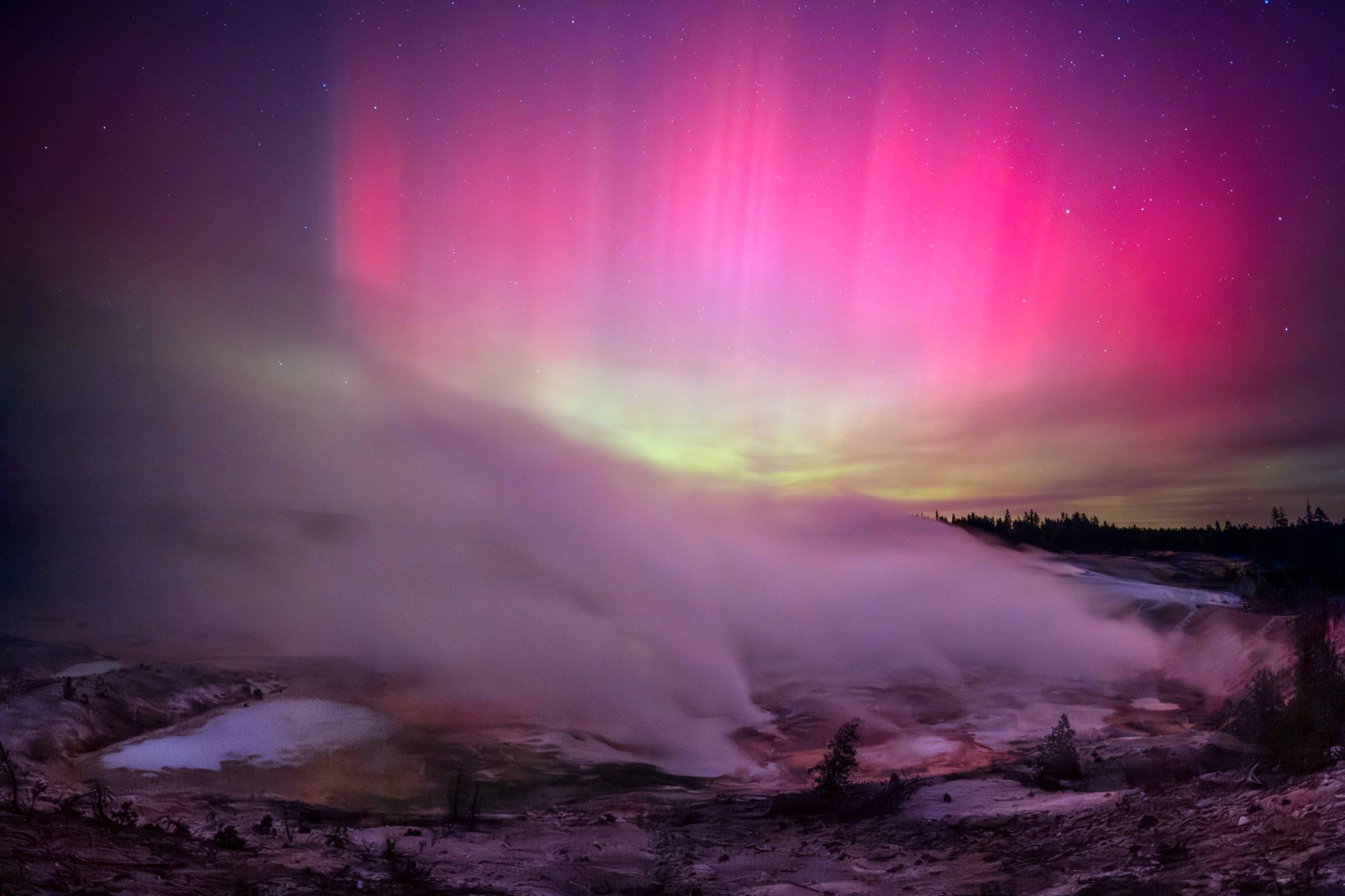 aurora over porcelain basin in yellowstone