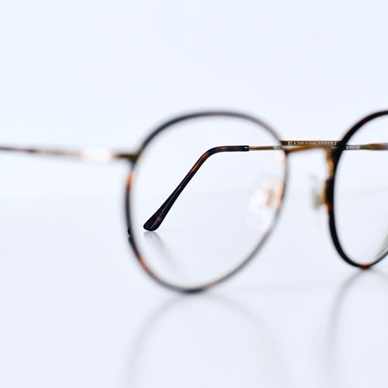 silver framed eyeglasses on white background