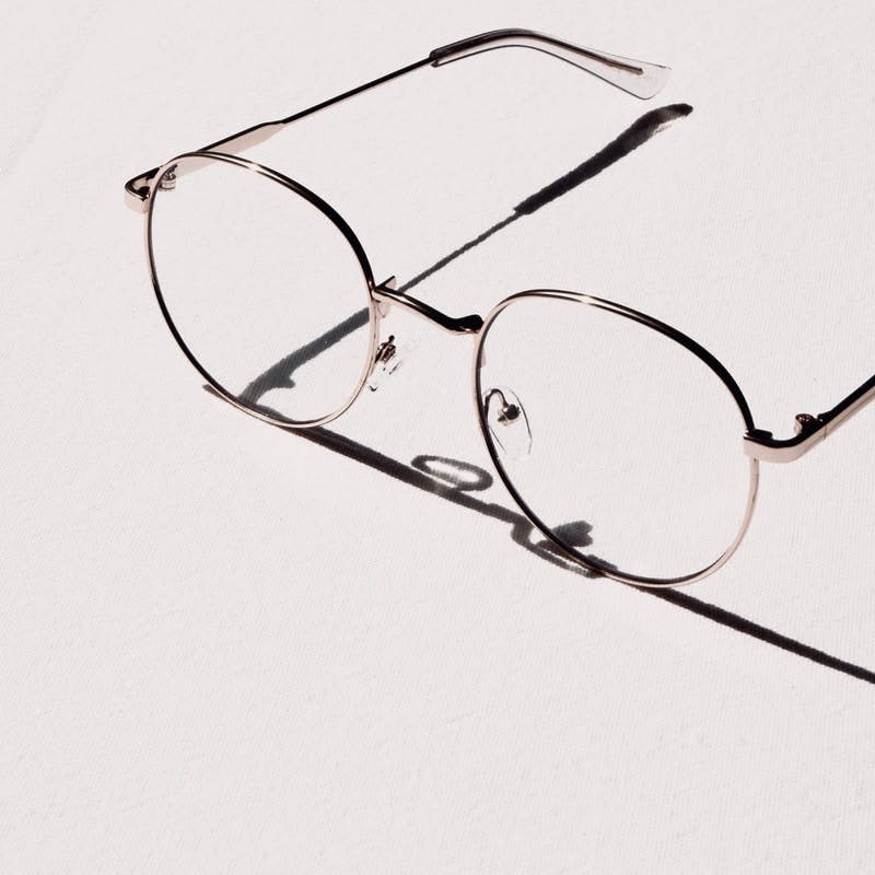 silver framed eyeglasses on white table
