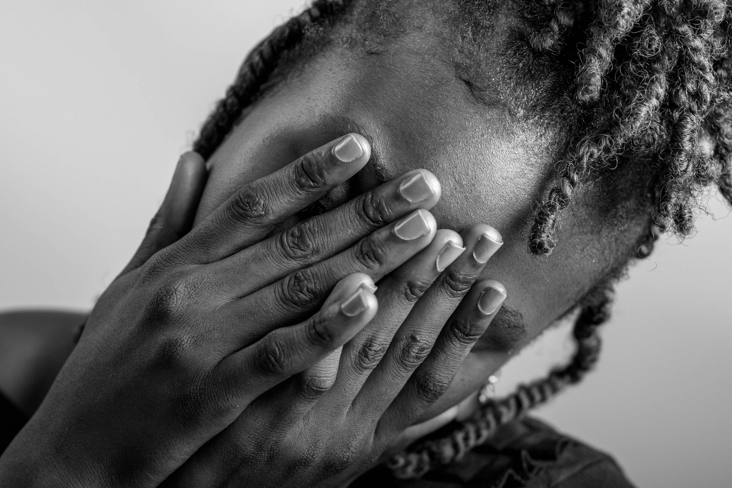 Black women covering her face 