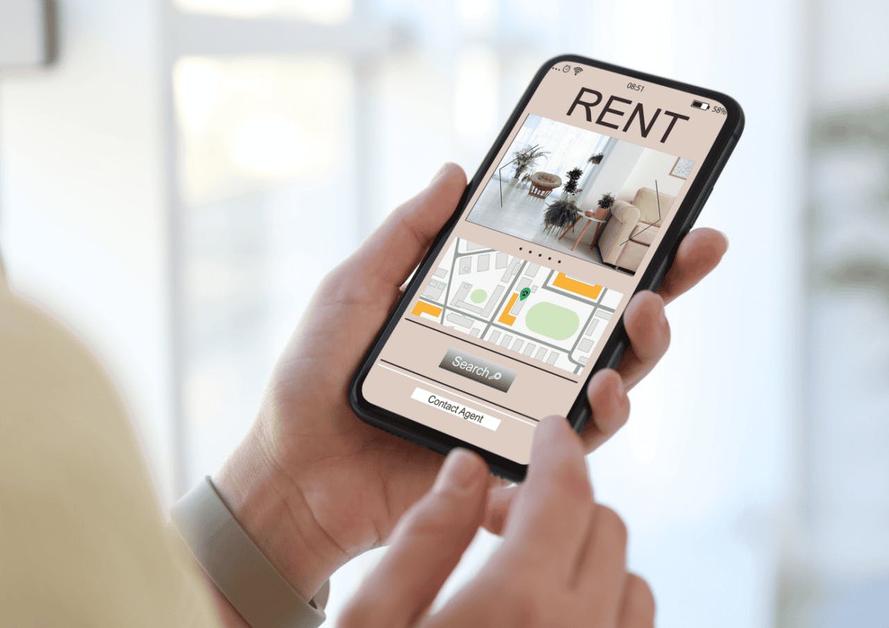 The image shows someone holding a mobile phone. On the screen is an image of a living room and a floorplan of an apartment. Underneath the images is a search button and a button to contact an agent.  This image conveys a Landlord’s Handbook for Effective Rental Property Marketing.