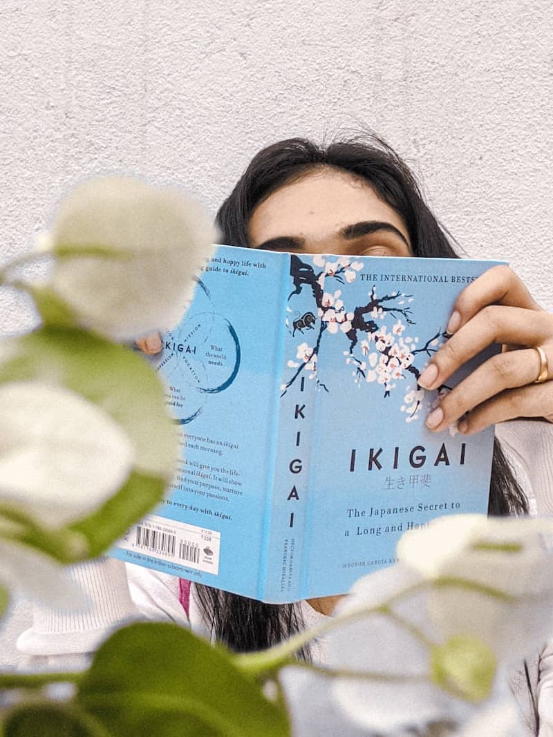 woman holding blue and white book