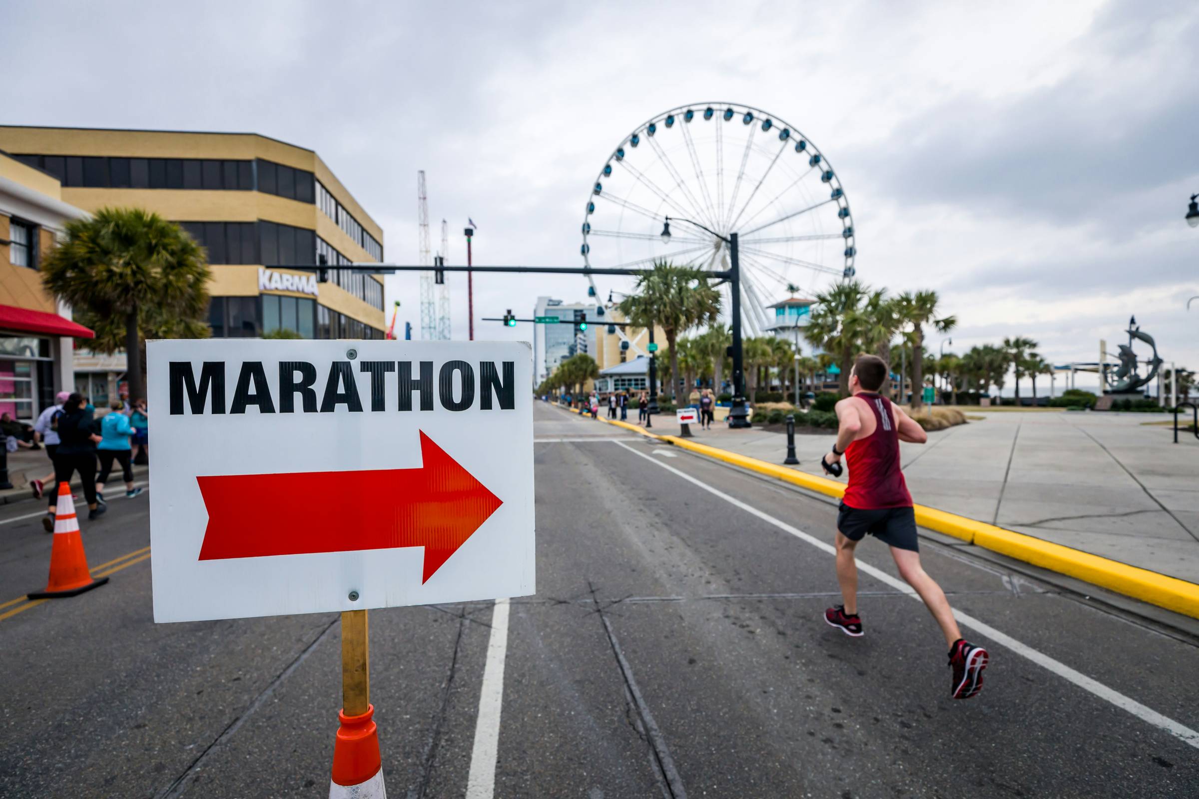 A runner with a sign that reads "marathon"