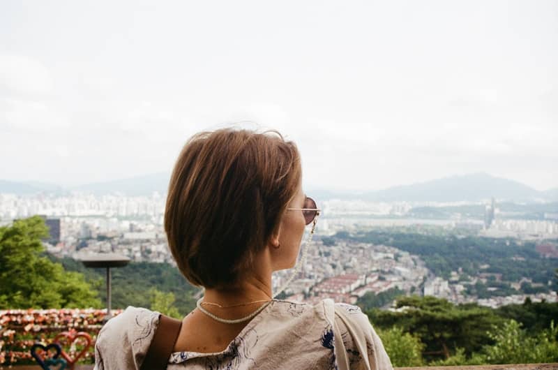 Woman looking out over a city skyline