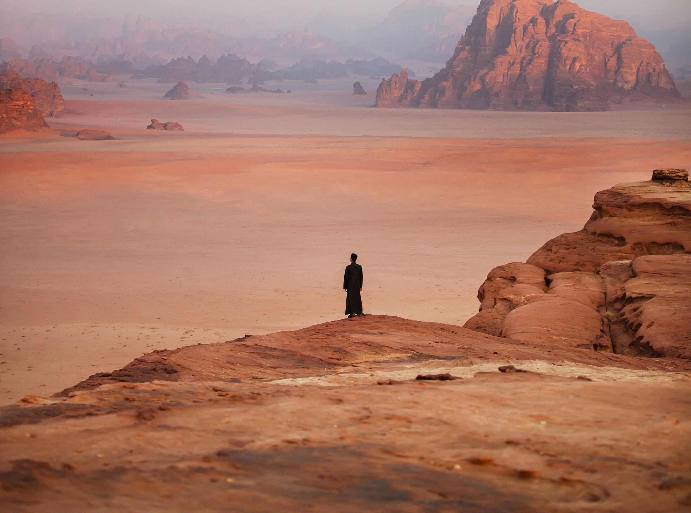 Woman standing alone in a distant desert