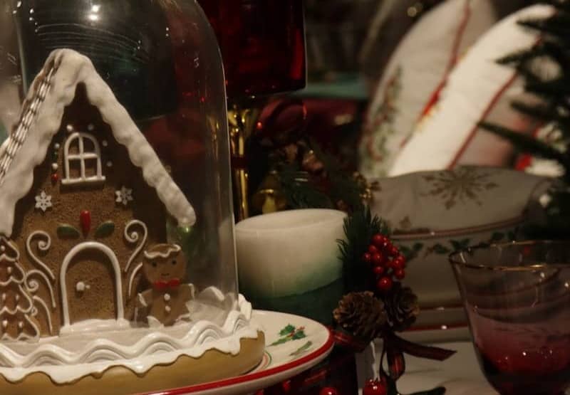 Gingerbread house under glass dome with christmas decorations